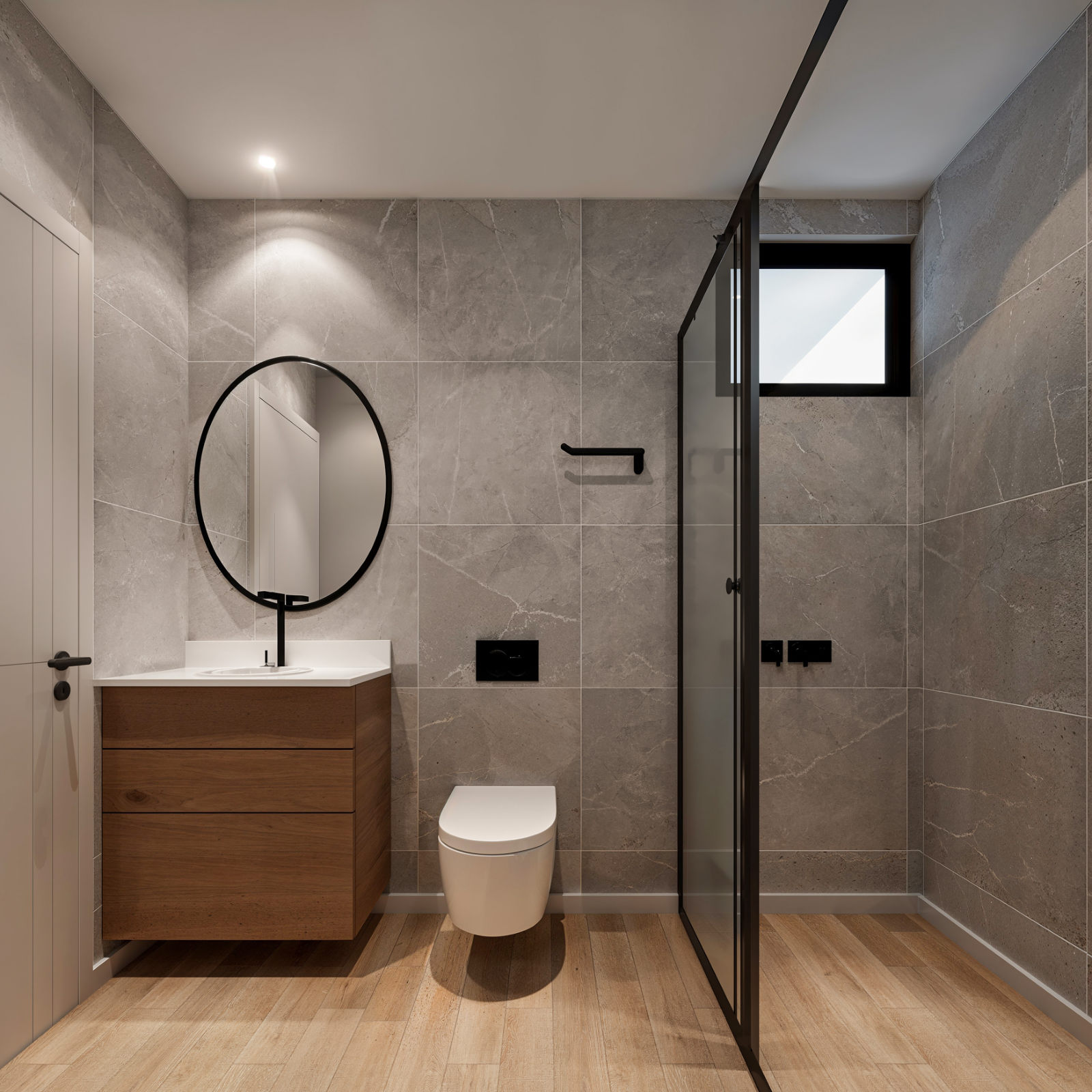 Baño con revestimiento de piso a techo y box de vidrio